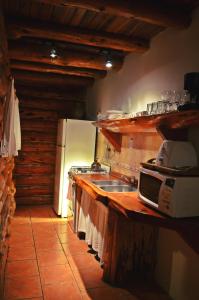 a kitchen with a sink and a microwave at La Campiña in San Carlos de Bariloche