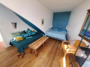 a living room with a couch and a bed at Gîte de La Tronchoyse entre vins et nature in Tronchoy