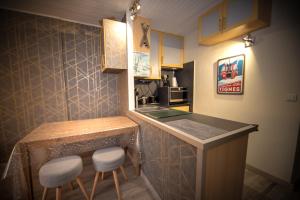 a kitchen with a counter and stools in a room at Le Rosset in Tignes
