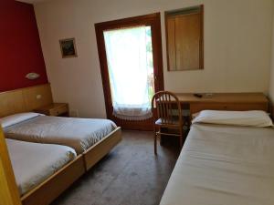 Letto o letti in una camera di Hotel Daniela