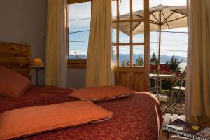 a bedroom with a bed and a large window at Lagos del Sur in San Carlos de Bariloche