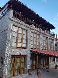 a building with windows and a balcony on top at Hotel Metoxi in Spiliá