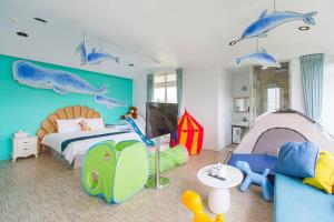 a childs bedroom with a bed and a tent at Footprint Garden B&B in Dongshan