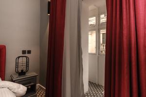 A bed or beds in a room at Casa Reale Boutique Hotel