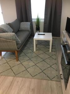 a living room with a couch and a coffee table at apartment Juurikoskenkatu in Ylivieska
