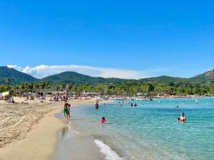 a group of people in the water at a beach at L'OCTOGONE in Grimaud