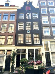 a tall building with flowers in front of it at Barrio Amsterdam in Amsterdam