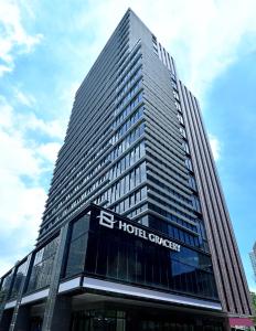 a tall building with a hotel synergy sign on it at Hotel Gracery Taipei in Taipei