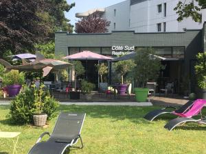 eine Gruppe von Stühlen und Tischen vor einem Restaurant in der Unterkunft Hotel du Casino in Saint-Valéry-en-Caux