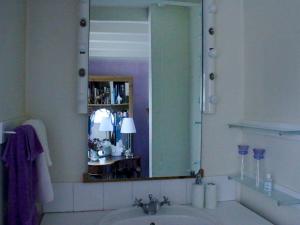 a bathroom with a sink and a large mirror at Stone House in Sulgrave