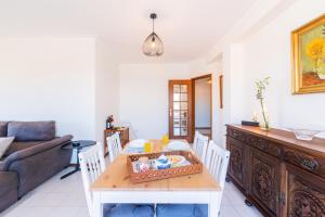 a living room with a table and a couch at Espinho Sunshine Flat in Espinho