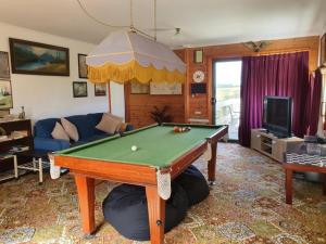 a living room with a pool table at Cobden Crest Cottages in Cobden