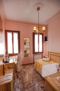 a bedroom with a bed and a sink and a mirror at Hotel Al Piave in Venice