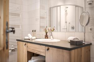 a bathroom with a sink and a mirror at Kristallhütte in Zellberg