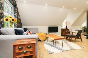 a living room with a couch and a table at Robin's Nest at The Shire Inn in Camborne