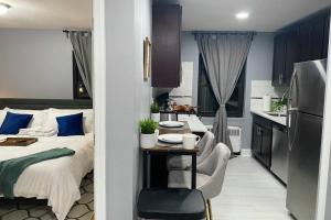 a bedroom with a bed and a table and a kitchen at Reduced Priced! Apt by American Dream, Sleeps 6 in Lodi