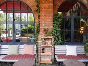 two benches in front of a brick building with windows at Gastwerk Hotel Hamburg in Hamburg