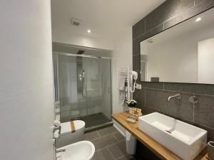 a bathroom with a sink and a toilet and a mirror at Nature Room in Olbia +12 photos