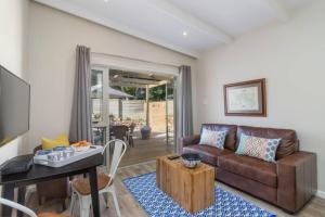 a living room with a couch and a table at Flow in Knysna