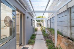 a walkway in a building with a glass ceiling at Flow in Knysna