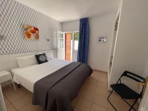 a bedroom with a large bed and a window at Rainbow Golf Bungalows, Gay Men-only Resort in Maspalomas +37 photos