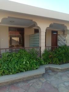 ein Haus mit grünen Pflanzen davor in der Unterkunft The Lahe Hotels in Mwanza