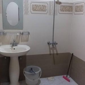 a bathroom with a sink and a toilet and a mirror at Hotel De Rose Wood Batakundi in Dumri