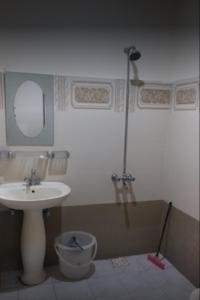 a bathroom with a sink and a toilet and a mirror at Hotel De Rose Wood Batakundi in Dumri