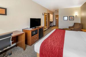a hotel room with a bed, television and a desk at Comfort Inn & Suites San Francisco Airport West in San Bruno