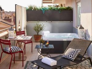 a hot tub on a balcony with a table and chairs at Hotel Mercure Roma Corso Trieste in Rome