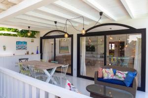 a porch with a table and chairs and a dining room at Villa Simba in Corralejo