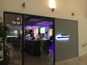
a restaurant with a large glass door at Belaire Suites Hotel in Durban
