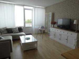 a living room with a couch and a tv at Vakantieappartment Duplex Aquadelta in Bruinisse