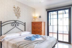 a bedroom with a bed with towels on it at Villa Simba in Corralejo +40 photos