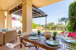 a wooden table and chairs on a patio at BELLA GADEA in Altea