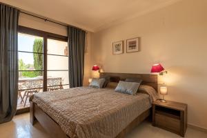 a bedroom with a bed and a balcony at BELLA GADEA in Altea +29 photos
