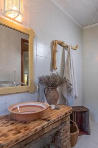 a bathroom with a large wooden sink on a counter at AMNISIADES APARTMENTS in Karteros