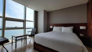 Postel nebo postele na pokoji v ubytování MS Hotel Haeundae