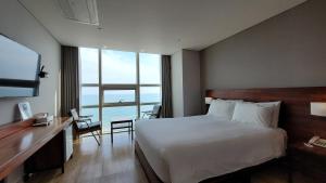 Postel nebo postele na pokoji v ubytování MS Hotel Haeundae
