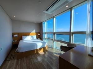 Postel nebo postele na pokoji v ubytování MS Hotel Haeundae