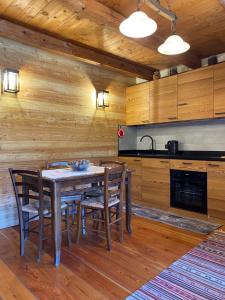 a kitchen with a table and chairs in a room at Frazione Duc Apartments in Sestriere