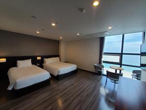 Postel nebo postele na pokoji v ubytování MS Hotel Haeundae