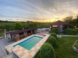 a swimming pool in a yard with a gazebo at Constancia in Kamianets-Podilskyi