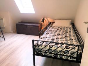 a bedroom with a bed and a dresser at Cottage T3 à 5 minutes à pied de la plage in Le Pouliguen +3 photos