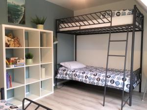 a bedroom with a bunk bed and a book shelf at Cottage T3 à 5 minutes à pied de la plage in Le Pouliguen