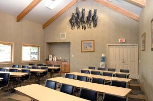 a classroom with tables and chairs and horses on the wall at C'mon INN Missoula in Missoula