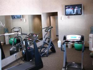 a room with a gym with a treadmill and a tv at C'mon INN Missoula in Missoula