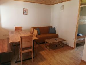 a living room with a couch and a table at Počitniška HIŠKA POLOVNIK in Bovec +9 photos