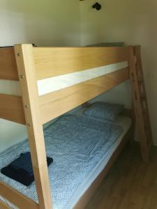 a bunk bed with a wooden bunk bed frame at Počitniška HIŠKA POLOVNIK in Bovec