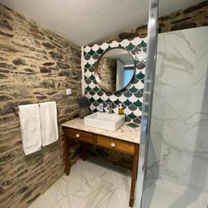 a bathroom with a sink and a mirror at Casa da Alfazema in Arganil +30 photos
